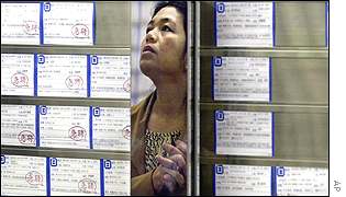 Woman checks employment bureau window