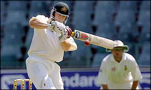 Adam Gilchist smashes the ball to the boundary