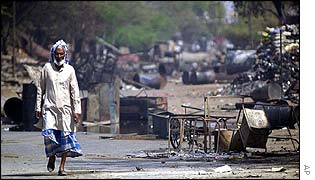 Yukub Qureshi walks through the rubble of an area near Ahmedabad