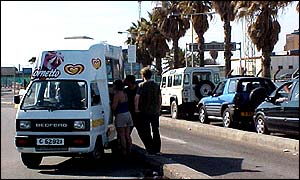 An ice-cream van beside the queue to cross the border