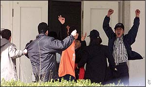 The group celebrates as they manage to get into the Spanish compound 