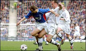 Ranger's Claudio Caniggia is tackled by John Hughes of Ayr United 