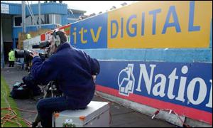 TV cameraman at football game