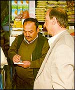 Ankara street vendor Veysel Genchauci serves a customer