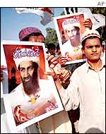 Pakistani demonstrators carry posters of Osama bin Laden