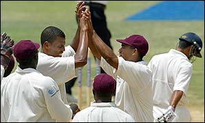 West Indies bowler Mervyn Dillon and Adam Sanford celebrate the dismissal of India's Ajay Ratra