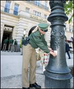 German policemen checks old lamp in front of Mr Bush's hotel