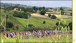 The pack of cyclists pedal through the countryside during stage ten