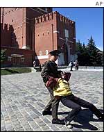A Kremlin guard tackles a protester in Red Square