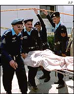 Police carry the injured away from the scene of the blast
