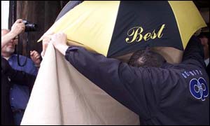 A strangely camera shy Schiffer left for the wedding under a blanket