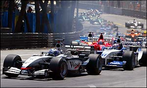 David Coulthard leads Juan Pablo Montoya and Michael Schumacher on the first lap