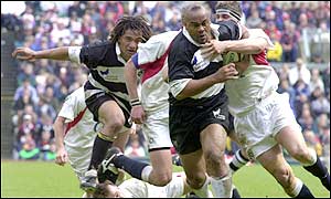 Barbarians Jonah Lomu, minus his right boot breaks the England defence
