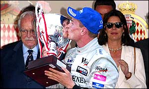 David Coutlthard embraces the trophy after winning the Monaco Grand Prix
