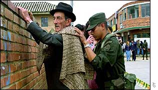 Soldier searches voter in La Calera, Bogota 