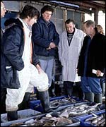 Men and fish in market BBC