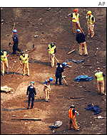 Recovery units from the New York City fire and police departments raking through debris in search for victims remains