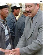 Azimbek Beknazarov, right, greets supporters outside a courtroom after he was convicted of corruption