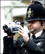 Policeman using video camera, PA