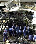 Police examine the wrecked bus