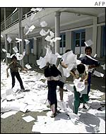 Children throwing around lists of candidates outside an abandoned polling station in Tadmait, Algeria