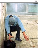 Berber protester prepares to throw stones 