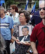 Milosevic supporter carries a portrait of him at a Belgrade rally