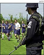 A soldier guards the US squad as they train