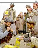 Refugees checking ration bags