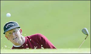 Scotland's Colin Montgomerie playing out of the greenside bunker on the 15th hole