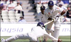 England's Alex Tudor survives after Sri Lankan fielder Russell Arnold stretches but fails to gather the ball during the third day of the second Test