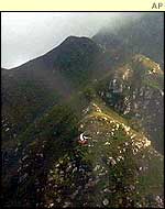 Plane wreckage lies on mountainside