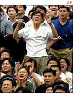 Chinese fans watch the game broadcast on a giant screen