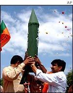 BJP youth wing members hold up a dummy of India's nuclear capable, Agni-3 missile 