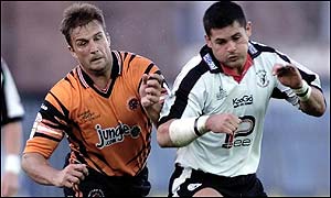 Castleford's Wayne Bartrim tussles with Widnes' Craig Weston