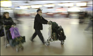 Travellers moving through Heathrow airport
