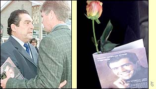 Frans Cronje is consoled by friends and family and the memorial booklet and rose available to the mourners