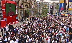 Fans watch the match in the Exchange in Manchester
