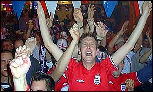Fans corss their fingers in the Globe Pub in Port Stanley, Falkland Islands