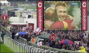 The crowd celebrates as David Beckham scores his penalty