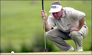 Darren Clarke of Northern Ireland eyes up a putt on the 16th to go in overnight with 13-under-par