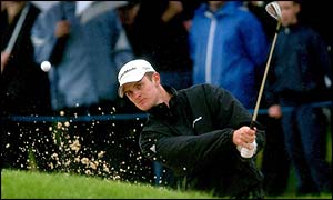 Englishman Justin Rose chips out of the bunker on to the green