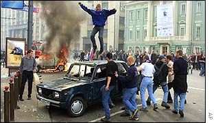 Rioter dancing on car
