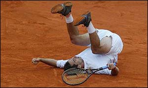 Albert Costa tumbles to the ground in joy after winning the French Open