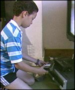 A child setting a video recorder
