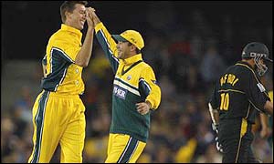 Australia's Glenn McGrath celebrates with team-mate Ricky Ponting after taking Shahid Afridi 's wicket