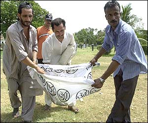 Parts of victims' bodies are carried from the scene by rescue workers