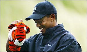 Tiger Woods is all smiles as he pulls the tiger club cover off of his driver 