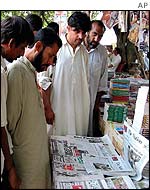 Karachi residents read newspapers