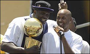 Shaquille O'Neal and Brian Shaw celebrate with the NBA trophy. 